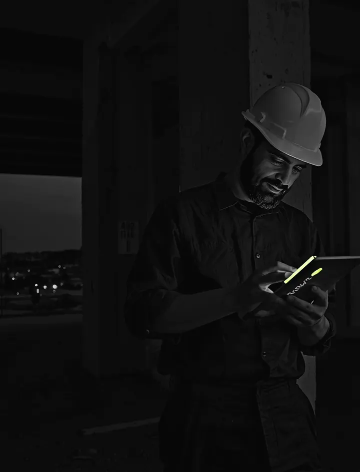 A building inspector on a construction site records a step on a tablet